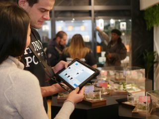 Two coworkers using a tablet