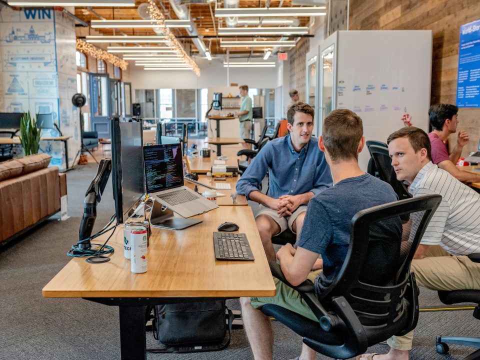 Professionals in a meeting, collaborating on strategy.